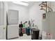 Functional laundry room with stacked washer/dryer and storage solutions at 6000 W Floyd Ave # 214, Denver, CO 80227