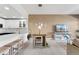 Bright living room with open floor plan to kitchen with bar seating at 6000 W Floyd Ave # 214, Denver, CO 80227