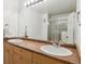 Bright bathroom with double sinks, spacious mirror, and glass-enclosed shower at 5708 E 10Th Ave, Denver, CO 80220
