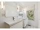 Modern bathroom featuring double sinks, streamlined mirrors and a window at 5708 E 10Th Ave, Denver, CO 80220