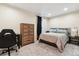 Cozy bedroom featuring neutral tones, carpet flooring, and a comfortable bed setting with natural light at 5708 E 10Th Ave, Denver, CO 80220