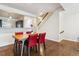 Dining room with hardwood floors, red chairs, and view of the staircase at 5708 E 10Th Ave, Denver, CO 80220