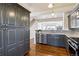 Stylish kitchen with stainless steel appliances, granite countertops, and elegant gray cabinetry at 5708 E 10Th Ave, Denver, CO 80220