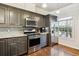 Stylish kitchen with stainless steel appliances, grey cabinets and granite countertops at 5708 E 10Th Ave, Denver, CO 80220