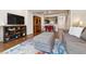 Open-concept living room with hardwood floors, comfortable seating, and a view of the dining area at 5708 E 10Th Ave, Denver, CO 80220