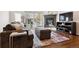 Cozy living room features a fireplace, large windows, comfortable seating, and stylish decor at 5708 E 10Th Ave, Denver, CO 80220