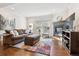Bright and airy living room with a cozy fireplace, comfortable seating, and stylish decor at 5708 E 10Th Ave, Denver, CO 80220