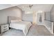 Spacious carpeted bedroom featuring a ceiling fan and a large bed with light gray walls at 5708 E 10Th Ave, Denver, CO 80220
