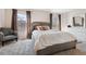 Carpeted main bedroom with large windows, upholstered headboard and neutral color palette at 5708 E 10Th Ave, Denver, CO 80220