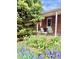 Inviting brick back porch and seating surrounded by beautiful flowers and lush greenery at 1965 Havana St, Aurora, CO 80010