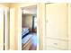 Bedroom view from hallway; features hardwood floors and soft rug at 1965 Havana St, Aurora, CO 80010