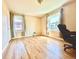 Bright bedroom featuring hardwood floors, neutral walls, and two sunny windows with stylish curtains at 1965 Havana St, Aurora, CO 80010