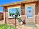 Close up of home entrance featuring a lovely garden bed and welcoming front door at 1965 Havana St, Aurora, CO 80010