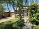 Charming brick home with a well-manicured front yard, pergola, and a detached single-car garage at 1965 Havana St, Aurora, CO 80010