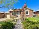 Charming brick home featuring a pergola and a well-manicured front yard at 1965 Havana St, Aurora, CO 80010