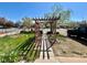Wooden pergola creates a welcoming entrance with a charming garden at 1965 Havana St, Aurora, CO 80010