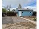 Exterior of detached blue garage with gravel driveway, fence, and some yard growth at 1965 Havana St, Aurora, CO 80010