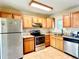 Well-lit kitchen featuring oak cabinets, stainless steel appliances, and granite countertops at 1965 Havana St, Aurora, CO 80010