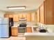 Bright kitchen with stainless steel appliances, oak cabinets, granite countertops and tile flooring at 1965 Havana St, Aurora, CO 80010