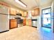 Functional kitchen featuring stainless steel appliances, wooden cabinets, and a tiled floor at 1965 Havana St, Aurora, CO 80010
