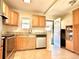 Cozy kitchen with oak cabinets, granite countertops, stainless steel appliances, and tile flooring at 1965 Havana St, Aurora, CO 80010