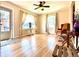 Bright living room with hardwood floors, ceiling fan, and natural light from large windows at 1965 Havana St, Aurora, CO 80010
