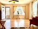 Bright living room with hardwood floors, ceiling fan, and natural light from a large window at 1965 Havana St, Aurora, CO 80010