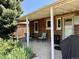 Covered patio with brick siding, outdoor seating, string lights, and a small table, perfect for relaxing at 1965 Havana St, Aurora, CO 80010
