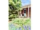 Cozy outdoor patio with seating, surrounded by lush greenery and blooming flowers, for relaxing outdoors at 1965 Havana St, Aurora, CO 80010