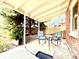 Charming covered patio featuring outdoor seating and a tranquil garden view at 1965 Havana St, Aurora, CO 80010