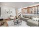 Spacious living room with L-shaped sofa and a view of the stairs at 1147 S Flower Cir, Lakewood, CO 80232