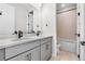 Bathroom with double sink vanity and shower-tub combo at 6633 Bridlespur St, Castle Pines, CO 80108