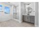 Bright bathroom showcasing a glass shower and a gray vanity with modern lighting and fixtures at 6633 Bridlespur St, Castle Pines, CO 80108
