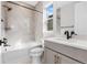 Bathroom with tub and shower, soft grey tile, and modern fixtures at 6633 Bridlespur St, Castle Pines, CO 80108