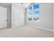 Bedroom featuring high ceilings, carpet, a large window, and closet at 6633 Bridlespur St, Castle Pines, CO 80108