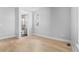 Bedroom featuring light hardwood floors, a window, and an ensuite bathroom at 6633 Bridlespur St, Castle Pines, CO 80108