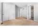 Bedroom featuring light hardwood floors, closet, and ensuite bathroom at 6633 Bridlespur St, Castle Pines, CO 80108