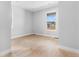 Bedroom featuring light hardwood floors and a bright window at 6633 Bridlespur St, Castle Pines, CO 80108