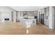 Bright kitchen with a central island, stainless steel appliances, and marble fireplace at 6633 Bridlespur St, Castle Pines, CO 80108