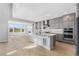 Open kitchen with stainless appliances, marble backsplash, and a view at 6633 Bridlespur St, Castle Pines, CO 80108