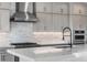 Close-up of a kitchen featuring gray cabinets and stainless-steel appliances at 6633 Bridlespur St, Castle Pines, CO 80108