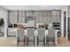 Modern kitchen featuring a spacious island with seating, stainless steel appliances, and elegant cabinetry at 6633 Bridlespur St, Castle Pines, CO 80108