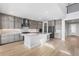 Open kitchen with stainless steel appliances, marble backsplash, and island at 6633 Bridlespur St, Castle Pines, CO 80108