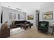 Living room featuring light hardwood floors, a sofa, and windows at 6633 Bridlespur St, Castle Pines, CO 80108