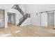 Open living room with hardwood floors, staircase, and sliding door at 6633 Bridlespur St, Castle Pines, CO 80108