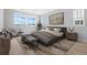 Cozy primary bedroom with stylish decor, a sitting area, and ample natural light from multiple windows at 6633 Bridlespur St, Castle Pines, CO 80108