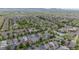 Vast aerial view of a residential neighborhood with green spaces and well-maintained streets at 8367 Devinney St, Arvada, CO 80005