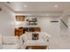 Cozy basement featuring a comfortable white sofa, wet bar, and stylish decor, with stairs leading to another level at 8367 Devinney St, Arvada, CO 80005