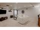 Finished basement featuring a comfortable white sofa, entertainment center, and stylish decor, perfect for relaxing at 8367 Devinney St, Arvada, CO 80005