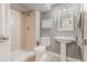 Neutral bathroom featuring a tiled shower with a rainfall shower head, pedestal sink, and gray walls at 8367 Devinney St, Arvada, CO 80005